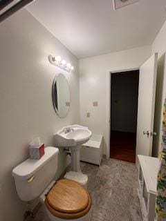 bathroom featuring toilet and sink