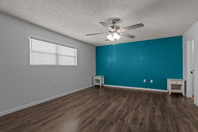 unfurnished bedroom featuring a textured ceiling, baseboards, a ceiling fan, and dark wood finished floors