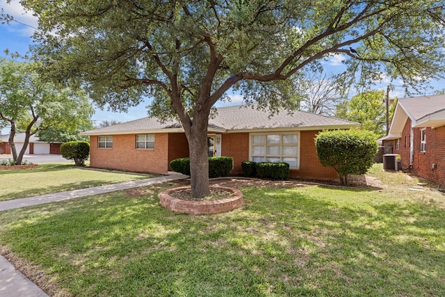 ranch-style house with central AC unit, brick siding, and a front lawn