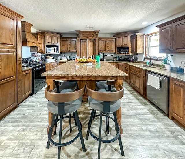 113 County Rd 405, Seminole, TX 79360 - kitchen featuring black range with electric cooktop, dishwasher, a kitchen island, a textured ceiling, and light stone counters