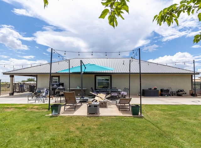 113 County Rd 405, Seminole, TX 79360 - back of house featuring stucco siding, a patio area, and a metal roof