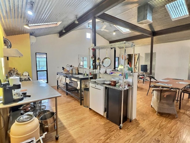 308 E Murphy St, Marfa, TX 79843 - kitchen with light wood-type flooring, a healthy amount of sunlight, refrigerator, and vaulted ceiling with beams