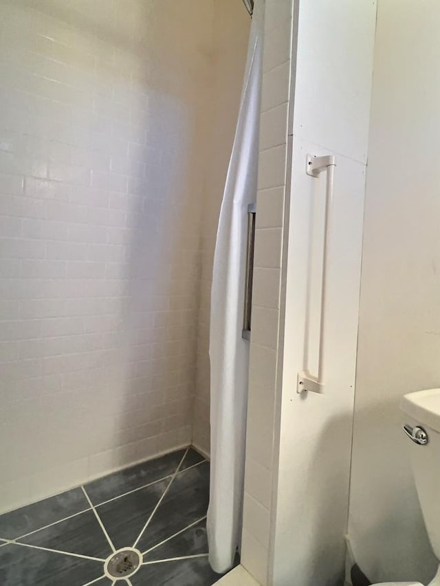 308 E Murphy St, Marfa, TX 79843 - bathroom with tile patterned flooring and toilet
