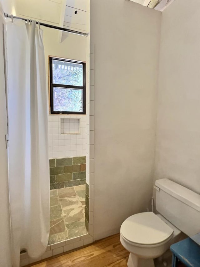 308 E Murphy St, Marfa, TX 79843 - full bath with toilet, wood finished floors, and tiled shower