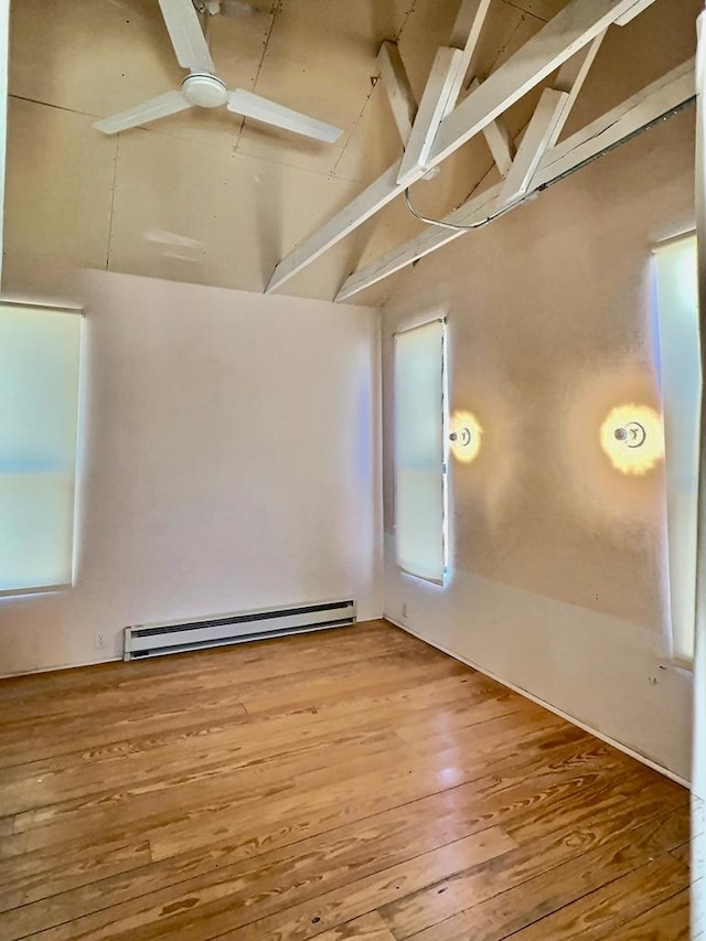 308 E Murphy St, Marfa, TX 79843 - spare room with a baseboard radiator, lofted ceiling with beams, a ceiling fan, and wood finished floors
