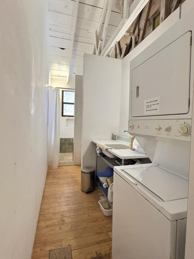 308 E Murphy St, Marfa, TX 79843 - washroom featuring a sink, laundry area, light wood-style flooring, and stacked washer and dryer