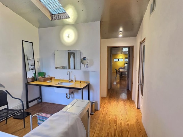 308 E Murphy St, Marfa, TX 79843 - kitchen with a skylight, visible vents, a sink, and wood finished floors