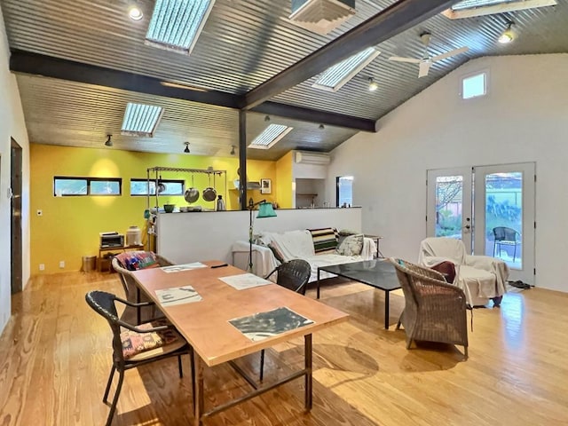308 E Murphy St, Marfa, TX 79843 - dining room featuring a skylight, french doors, beam ceiling, wood finished floors, and high vaulted ceiling