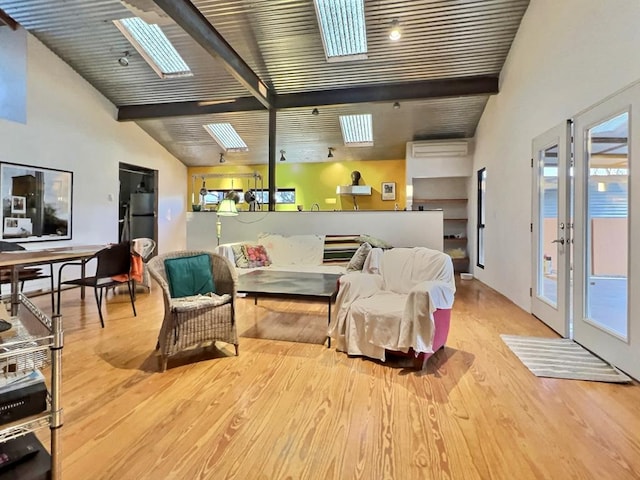 308 E Murphy St, Marfa, TX 79843 - living area featuring beam ceiling, wood finished floors, a skylight, and a wall unit AC