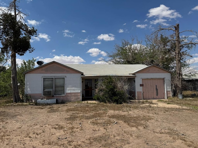 300 S Monahans Ave, Wink, TX 79789 - ranch-style home with a garage, concrete block siding, a metal roof, and cooling unit