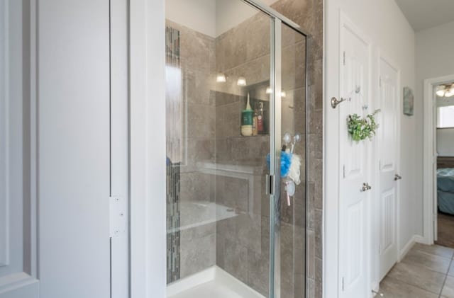 1614 Laguna Meadows Trl, Midland, TX 79705 - bathroom with a shower stall, connected bathroom, and tile patterned floors