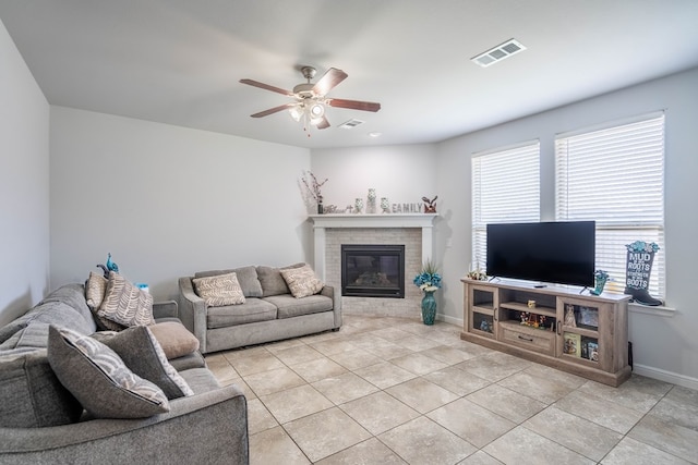 1614 Laguna Meadows Trl, Midland, TX 79705 - living room with a ceiling fan, light tile patterned floors, and a fireplace