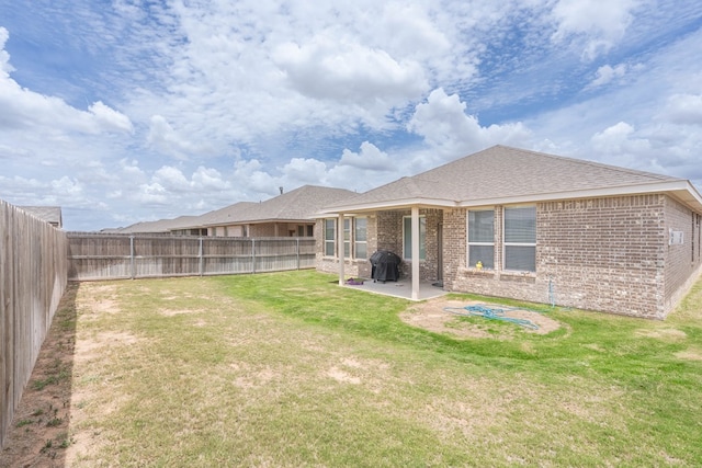 1614 Laguna Meadows Trl, Midland, TX 79705 - back of house with a patio, brick siding, a fenced backyard, and a shingled roof