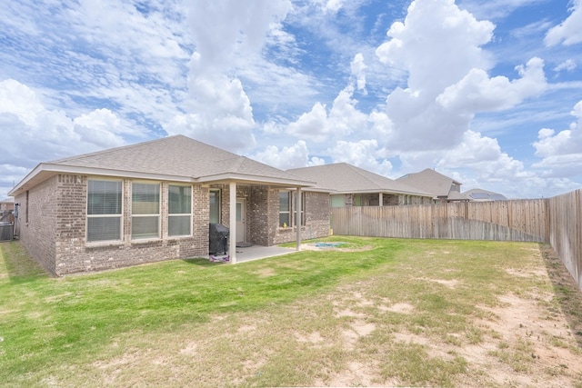 1614 Laguna Meadows Trl, Midland, TX 79705 - back of property featuring brick siding, a patio area, and a fenced backyard