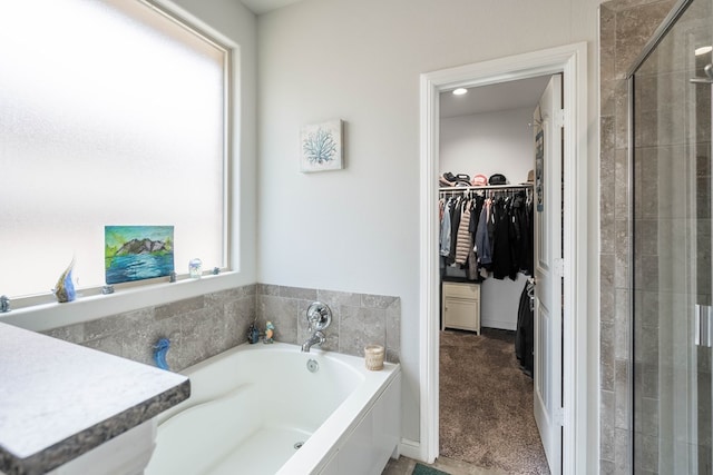 1614 Laguna Meadows Trl, Midland, TX 79705 - bathroom with a garden tub, a walk in closet, and a tile shower