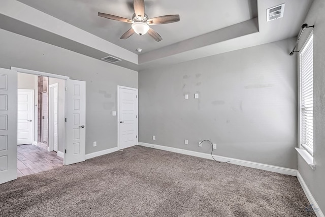 unfurnished bedroom featuring baseboards, ceiling fan, visible vents, and carpet floors