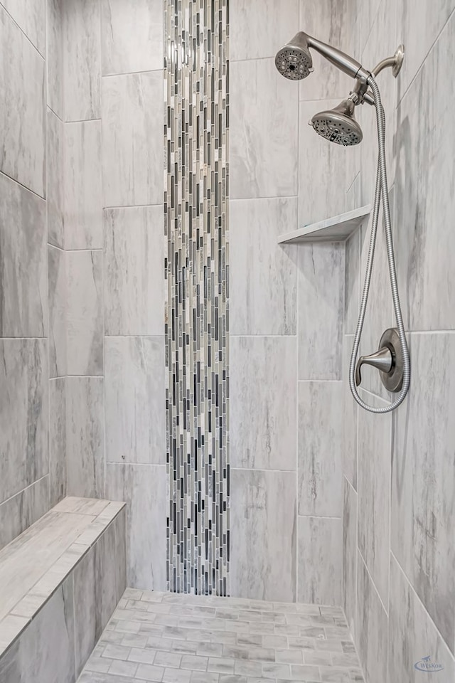 bathroom with tiled shower