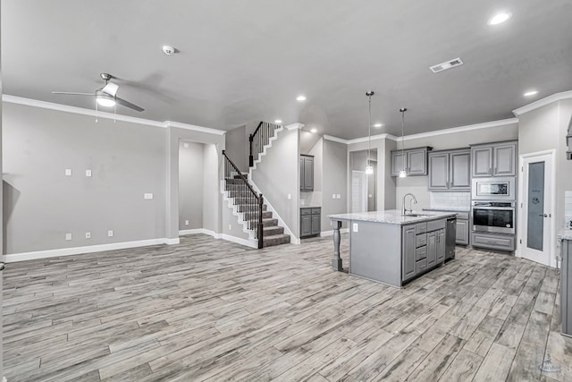 kitchen featuring a sink, visible vents, ceiling fan, gray cabinetry, and appliances with stainless steel finishes