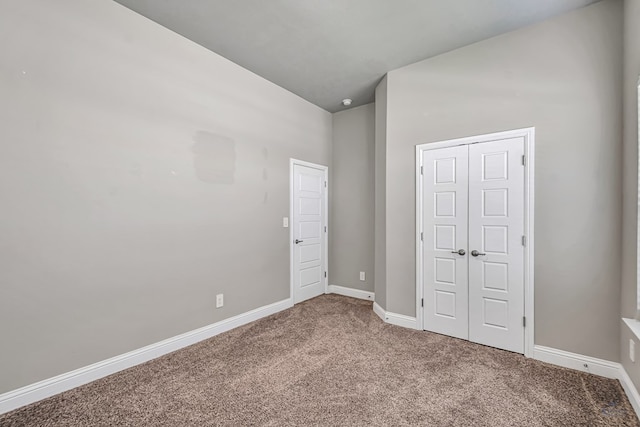 unfurnished bedroom featuring carpet flooring and baseboards