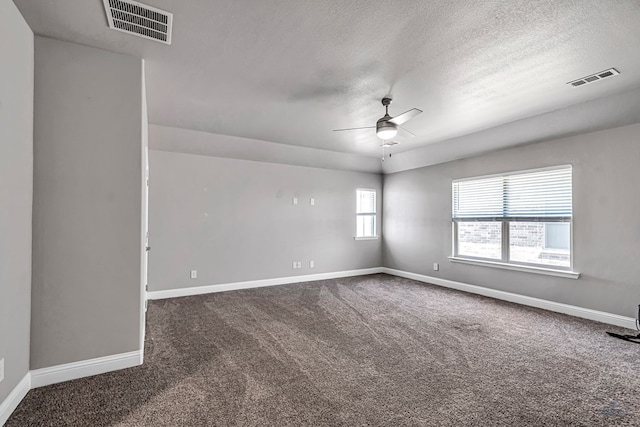 spare room featuring carpet, baseboards, a ceiling fan, and visible vents