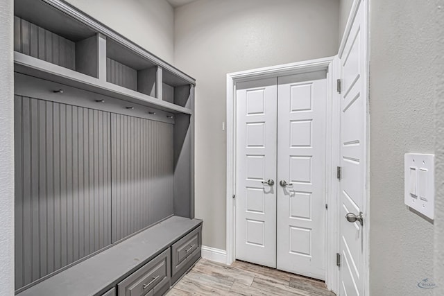 mudroom with baseboards and light wood finished floors