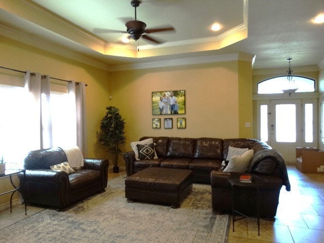 1 Warwick Dr, Odessa, TX 79765 - living area with a tray ceiling, ornamental molding, ceiling fan, and tile patterned floors