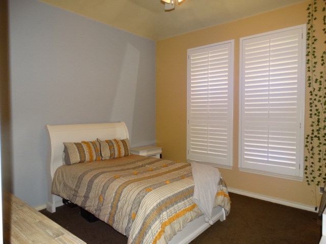 1 Warwick Dr, Odessa, TX 79765 - bedroom with baseboards, carpet floors, and ceiling fan