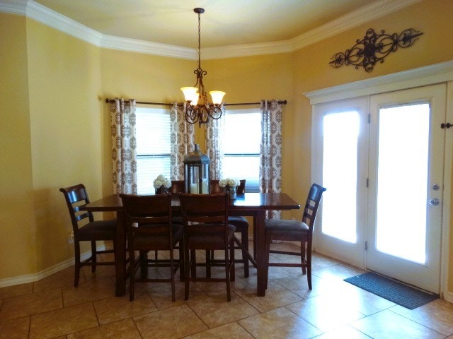1 Warwick Dr, Odessa, TX 79765 - dining area featuring a chandelier, ornamental molding, light tile patterned floors, and baseboards