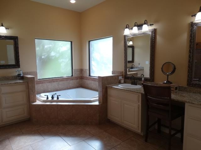 1 Warwick Dr, Odessa, TX 79765 - bathroom featuring a bath, tile patterned floors, and two vanities