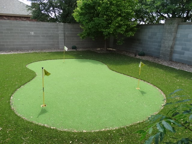 1 Warwick Dr, Odessa, TX 79765 - surrounding community featuring a putting green and a fenced backyard