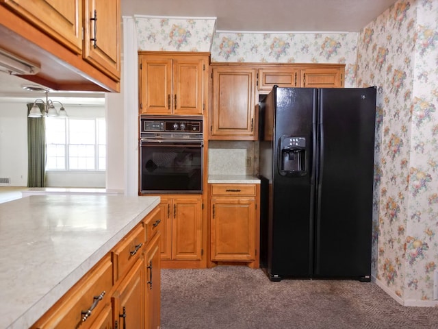2809 E 17th St, Odessa, TX 79761 - kitchen featuring black appliances, wallpapered walls, light countertops, carpet flooring, and brown cabinets
