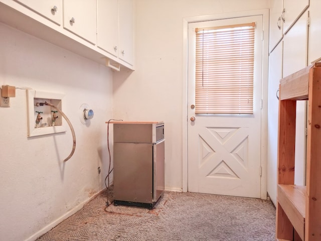 2809 E 17th St, Odessa, TX 79761 - laundry area with light carpet, cabinet space, and washer hookup