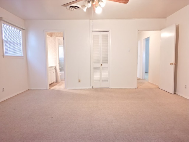 2809 E 17th St, Odessa, TX 79761 - unfurnished bedroom with light carpet, ensuite bathroom, a closet, and a ceiling fan