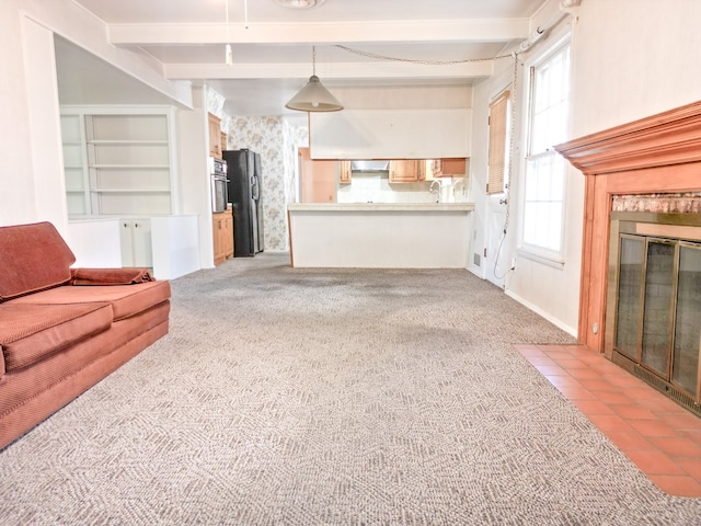 2809 E 17th St, Odessa, TX 79761 - unfurnished living room featuring beam ceiling, a fireplace with flush hearth, light carpet, and wallpapered walls