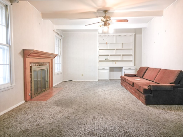 2809 E 17th St, Odessa, TX 79761 - living area featuring carpet, ceiling fan, beam ceiling, a fireplace with flush hearth, and built in study area