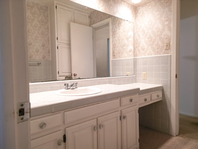 2809 E 17th St, Odessa, TX 79761 - bathroom with wallpapered walls, vanity, a wainscoted wall, and tile walls
