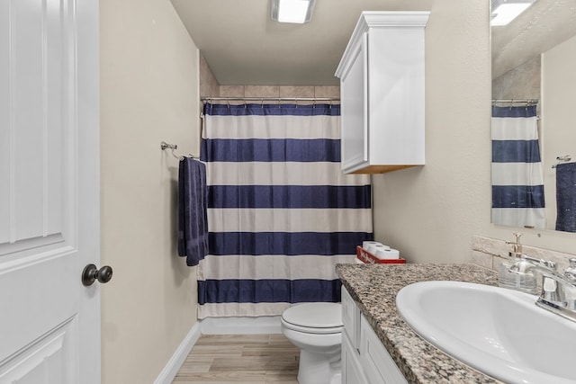 1214 Yancy St, Odessa, TX 79765 - bathroom with vanity, wood finished floors, and a shower with shower curtain