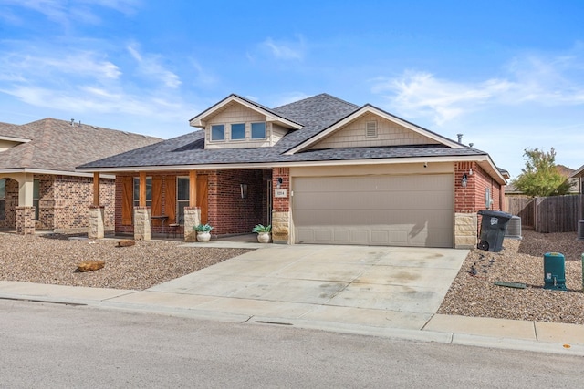 1214 Yancy St, Odessa, TX 79765 - view of front of property with a porch, brick siding, driveway, and a garage
