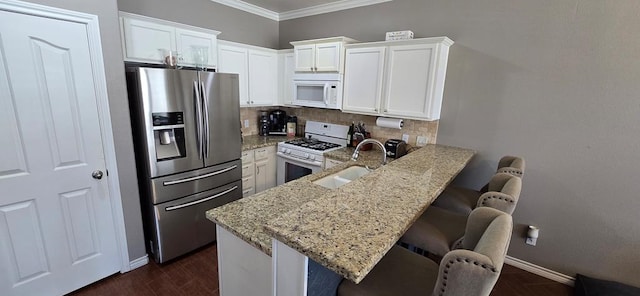 7266 Barksdale Ln, Odessa, TX 79765 - kitchen with white appliances, ornamental molding, decorative backsplash, light stone countertops, and white cabinets