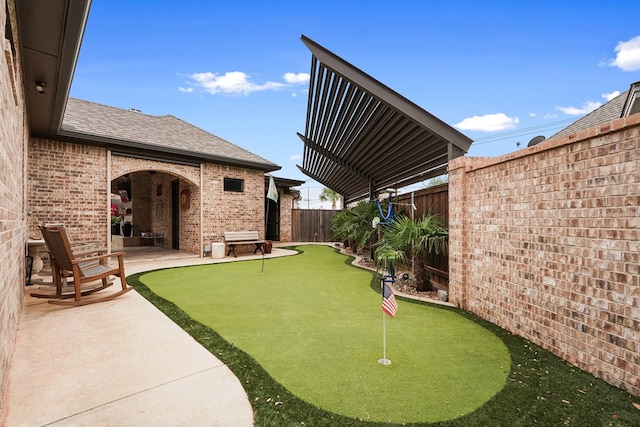 4309 Greenville Dr, Midland, TX 79705 - fenced backyard featuring a putting area and a patio