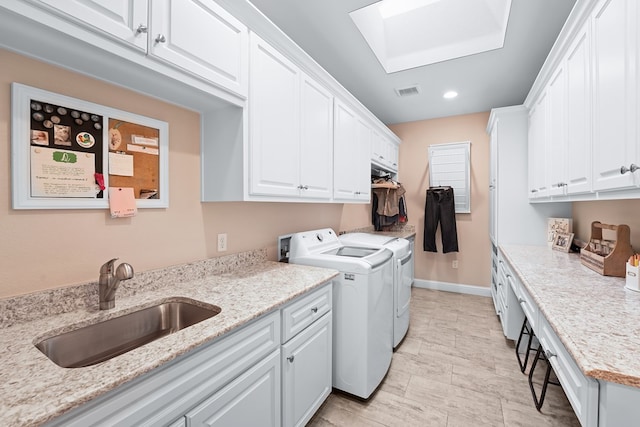 4309 Greenville Dr, Midland, TX 79705 - washroom with independent washer and dryer, cabinet space, a skylight, and recessed lighting