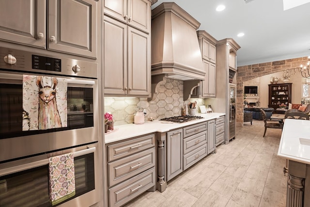 4309 Greenville Dr, Midland, TX 79705 - kitchen featuring stainless steel appliances, premium range hood, a fireplace, light countertops, and ornamental molding
