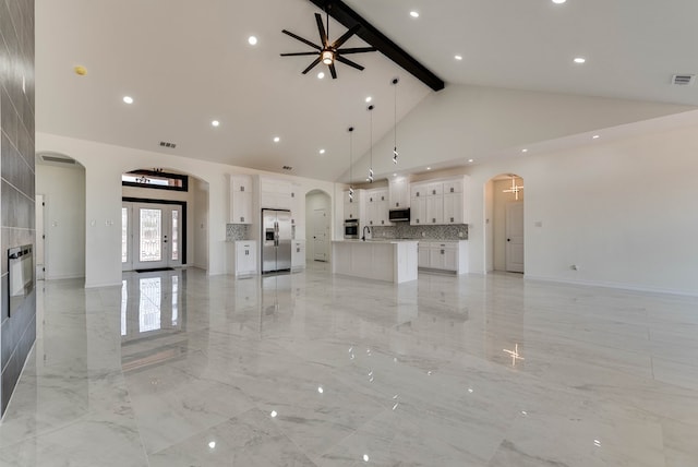 12045 W Palomino Ave, Odessa, TX 79764 - unfurnished living room featuring high vaulted ceiling, arched walkways, beam ceiling, a ceiling fan, and light marble finish flooring