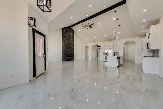 12045 W Palomino Ave, Odessa, TX 79764 - unfurnished living room featuring arched walkways, high vaulted ceiling, light marble finish flooring, ceiling fan, and recessed lighting