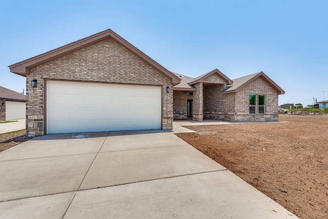 12045 W Palomino Ave, Odessa, TX 79764 - ranch-style home featuring brick siding, concrete driveway, and a garage