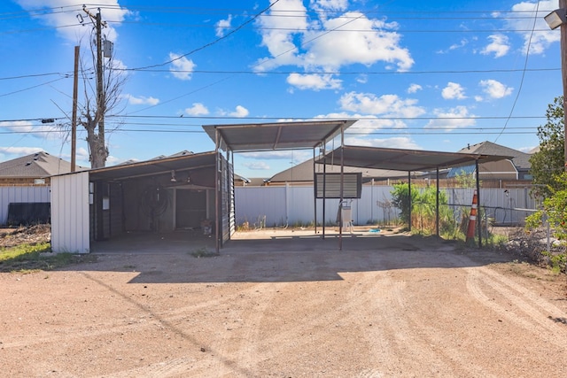 5714 Ector Ave, Odessa, TX 79714 - view of parking with dirt driveway and a detached carport