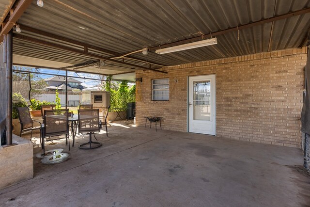 5714 Ector Ave, Odessa, TX 79714 - view of patio featuring outdoor dining space and a storage unit