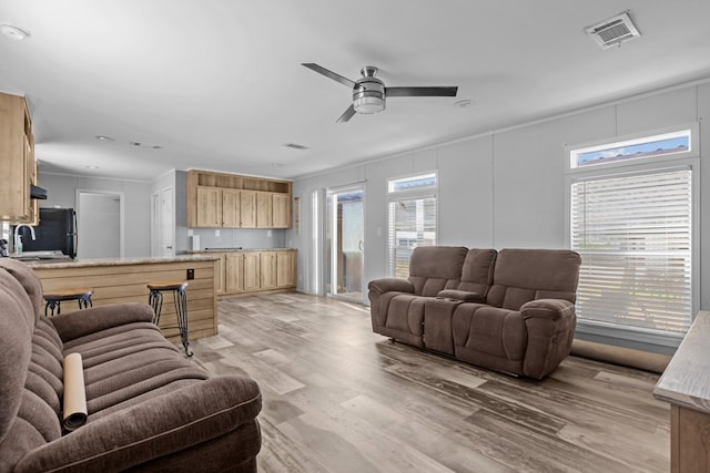 5714 Ector Ave, Odessa, TX 79714 - living area with light wood finished floors, a ceiling fan, and ornamental molding