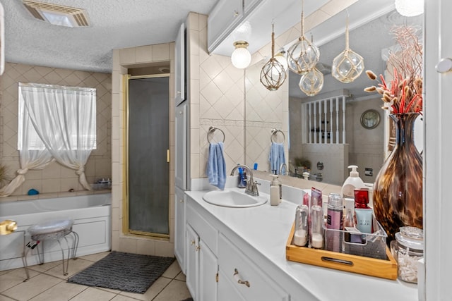 5714 Ector Ave, Odessa, TX 79714 - full bath featuring tile patterned flooring, a stall shower, a garden tub, vanity, and a textured ceiling