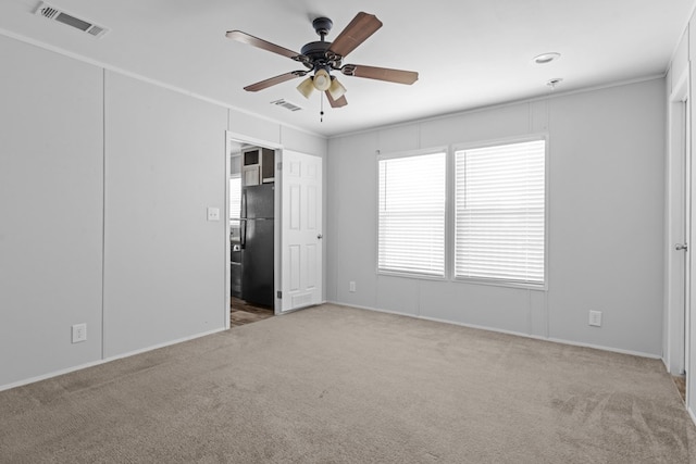 5714 Ector Ave, Odessa, TX 79714 - unfurnished bedroom with carpet, freestanding refrigerator, crown molding, and ceiling fan